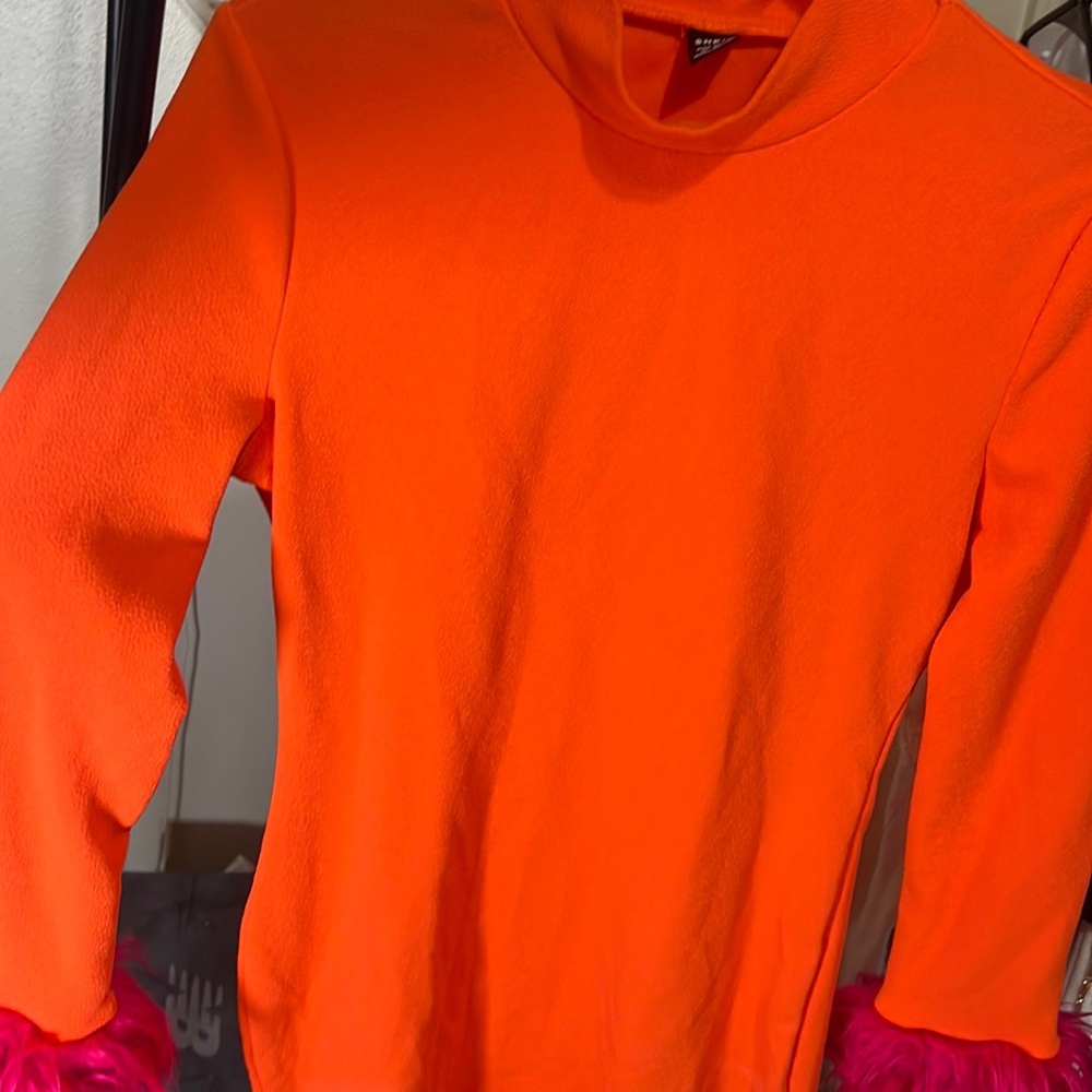 Orange fitted dress with pink fuzzy at the end
